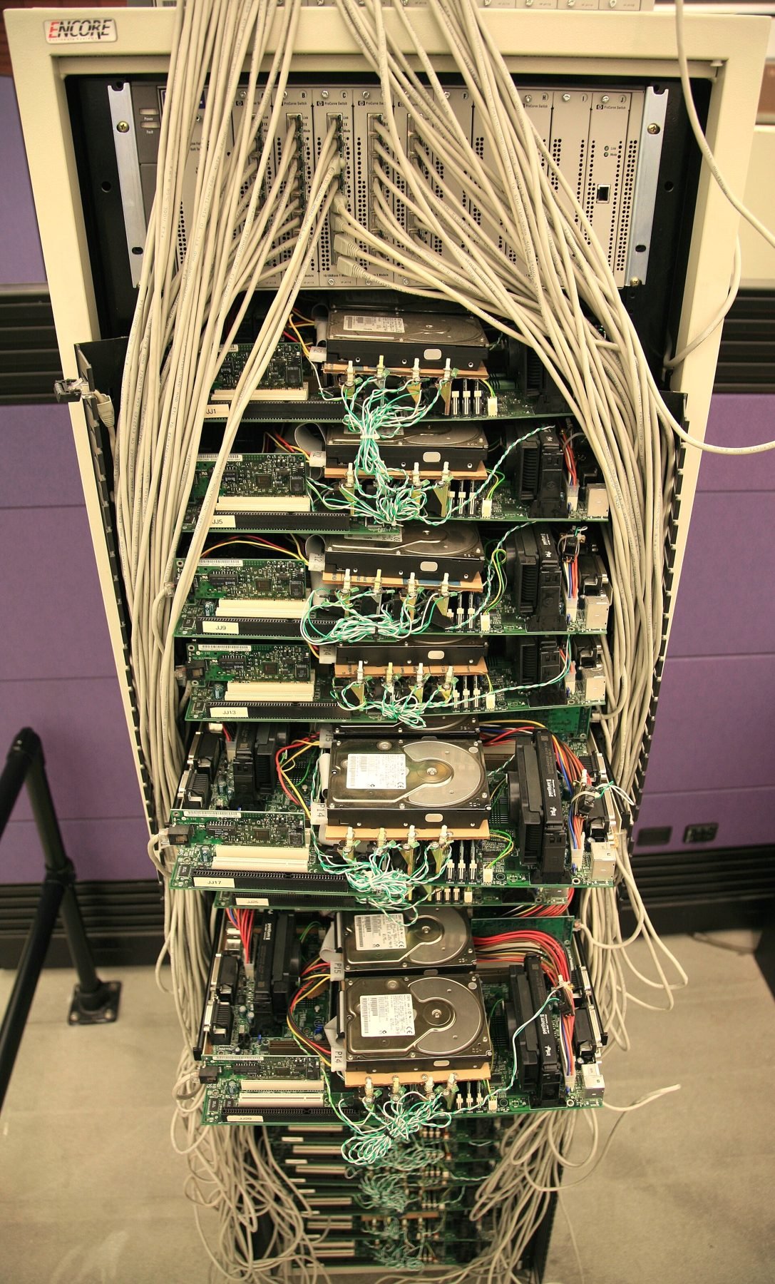 An open equipment cabinet showing dense cabling and circuit boards.